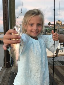 Girl holding fish on hook in Galveston Texas